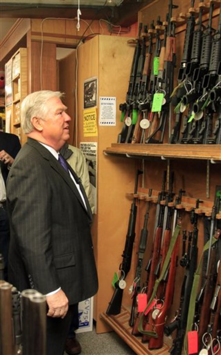 Possible Republican presidential candidate, Mississippi Gov. Haley Barbour looks at guns at Riley's Gun Shop, Thursday, April 14, 2011, in Hookset, N.H. (AP Photo/Jim Cole)
